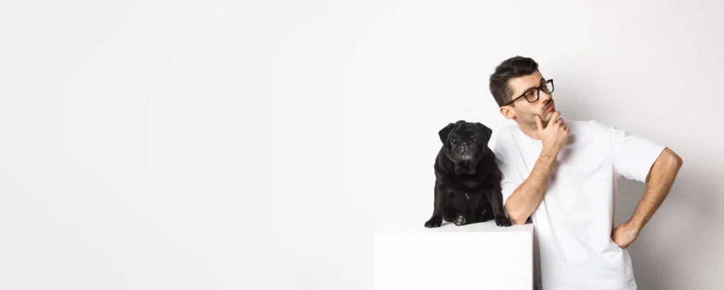 Handsom man standing with his female pet dog, thinking about female dog name